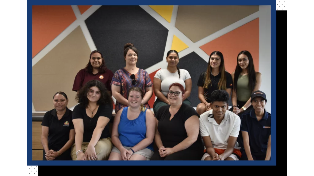 A photo of a group of people smiling at the camera.