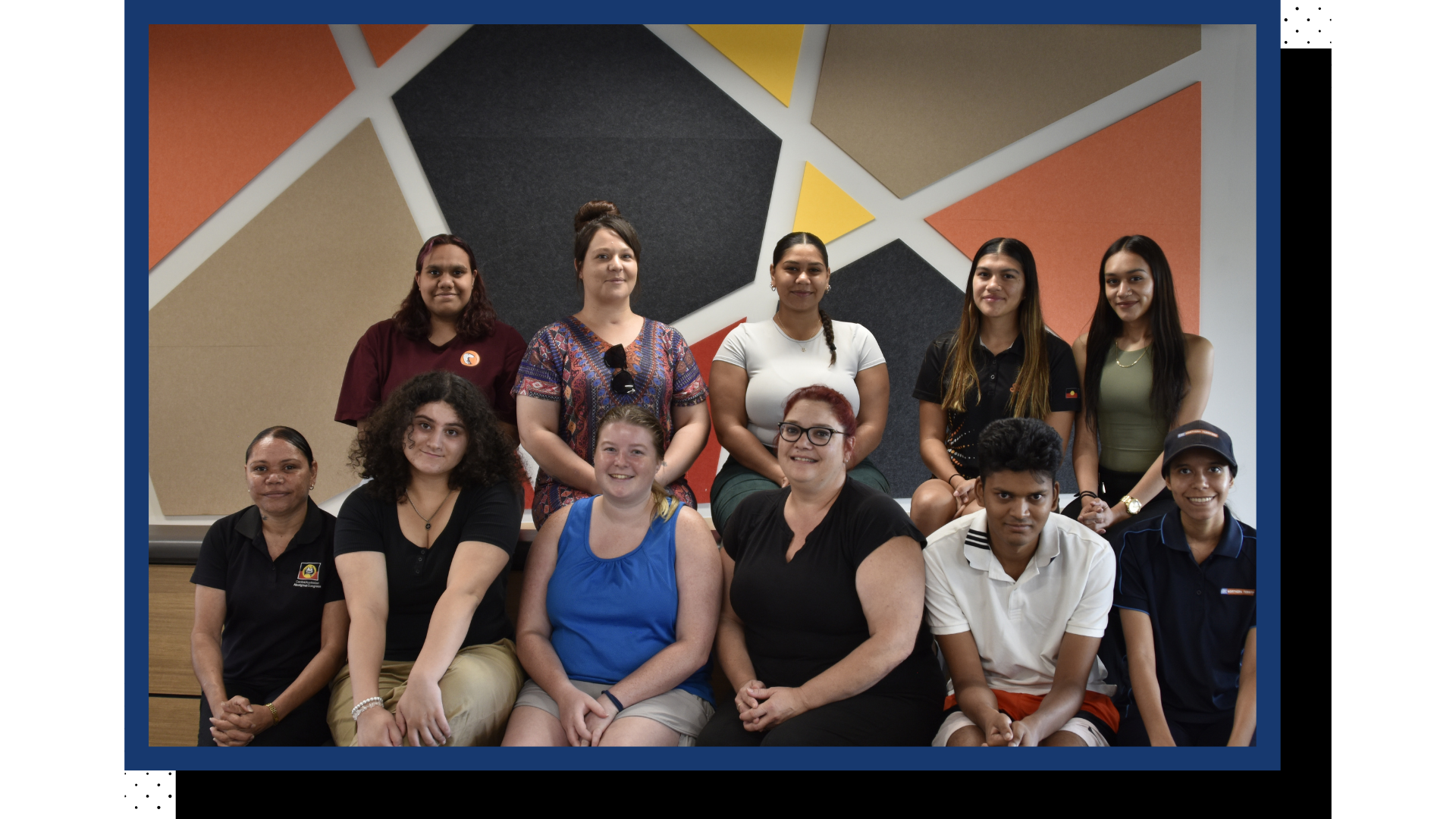 A photo of a group of people smiling at the camera.