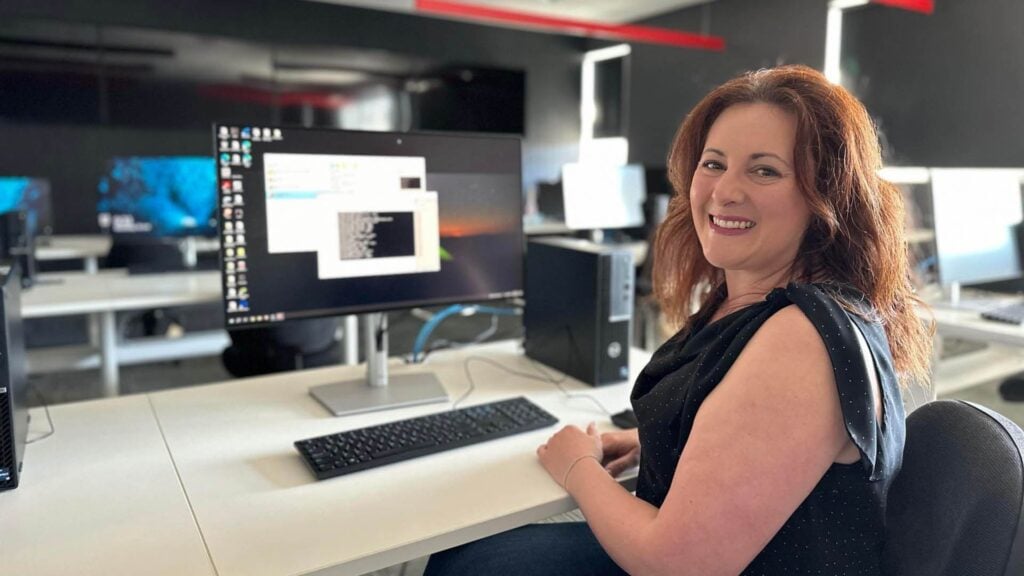 A photo of a woman smiling at the camera.