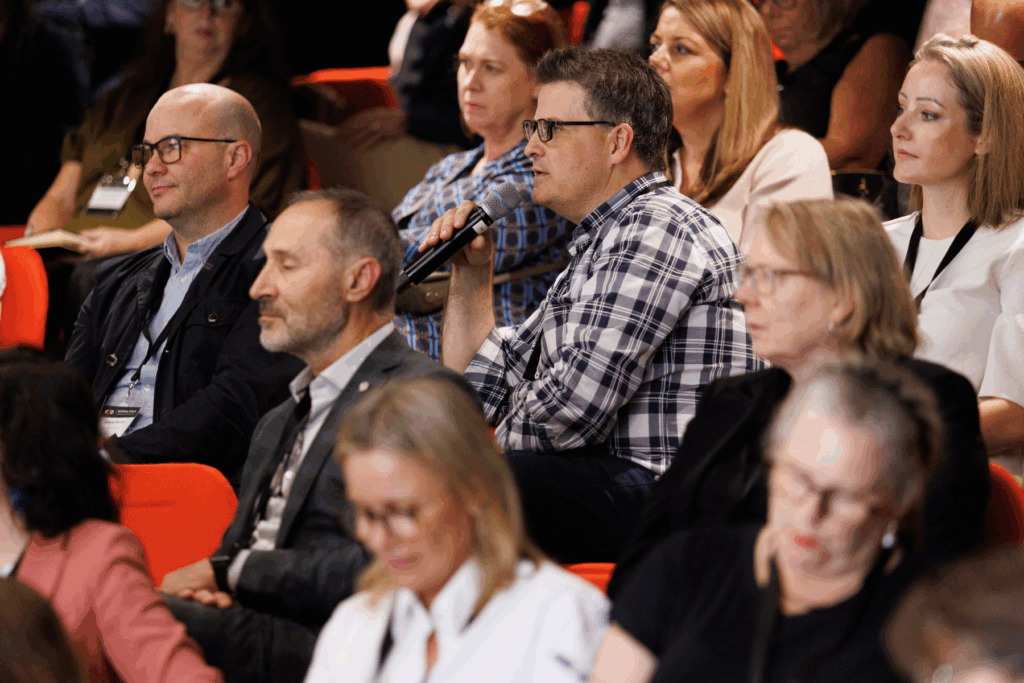 A photo of a crowd of people at a conference.