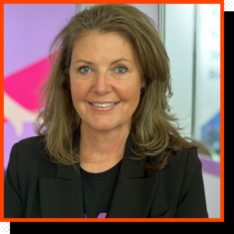 A photo of a woman smiling at the camera.