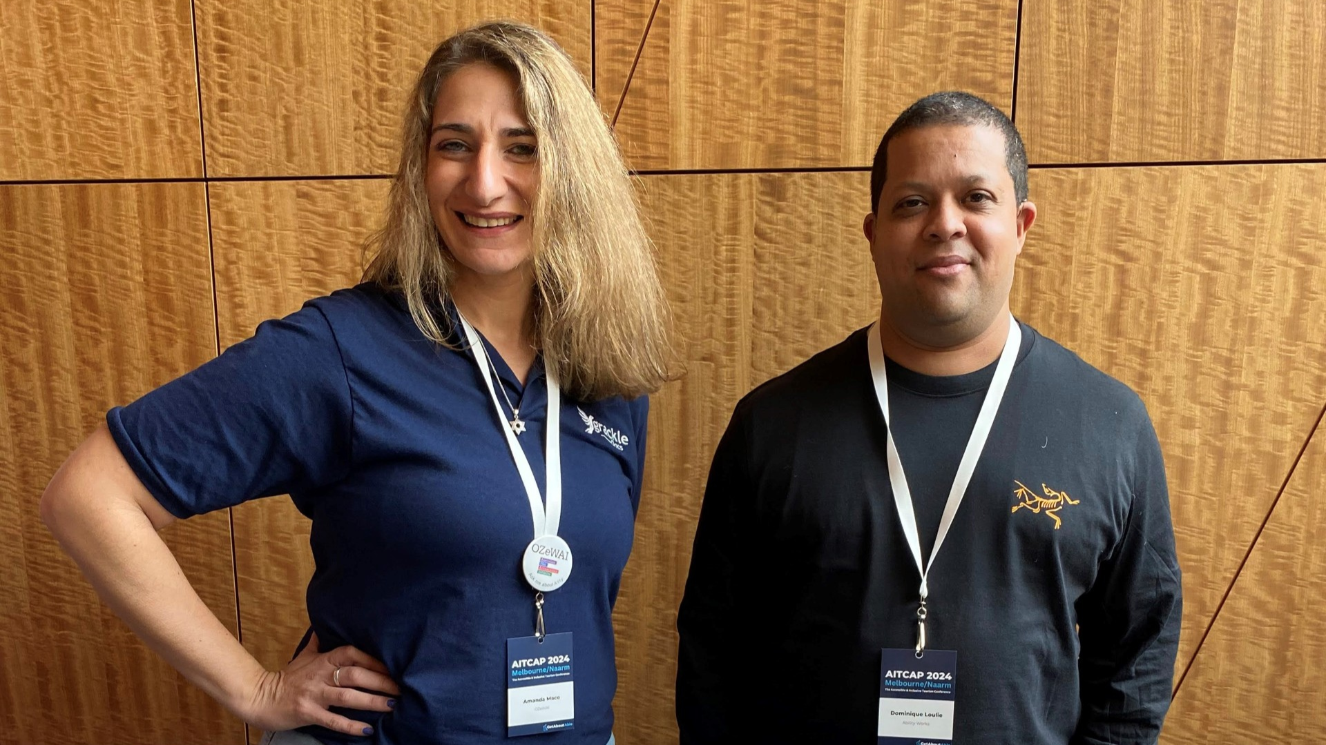 A photo of two people smiling at the camera.