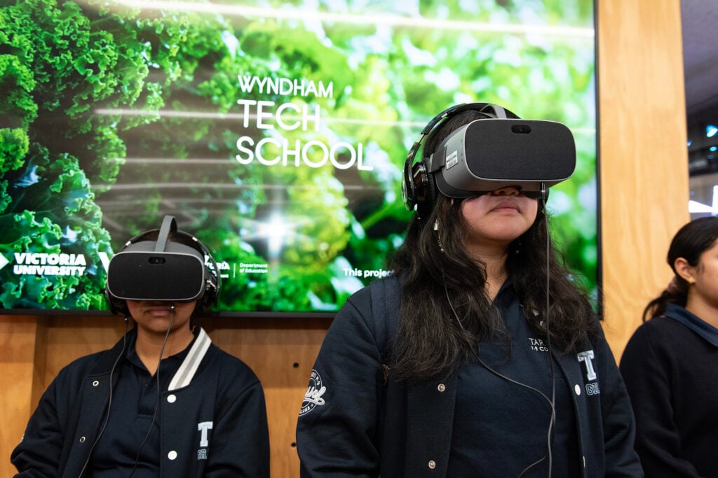 A photo of two children wearing VR headsets.