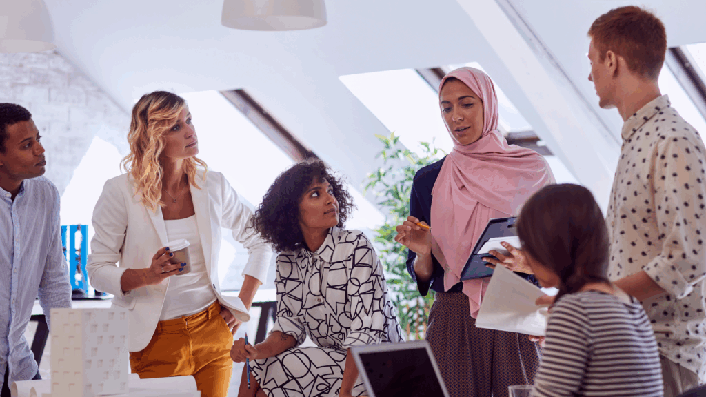 A photo of a group of people working in an office.